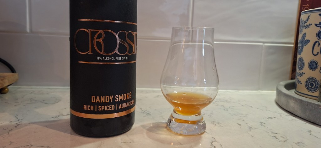 Crossip Dandy Smoke on a countertop with a sample poured into a glencairn