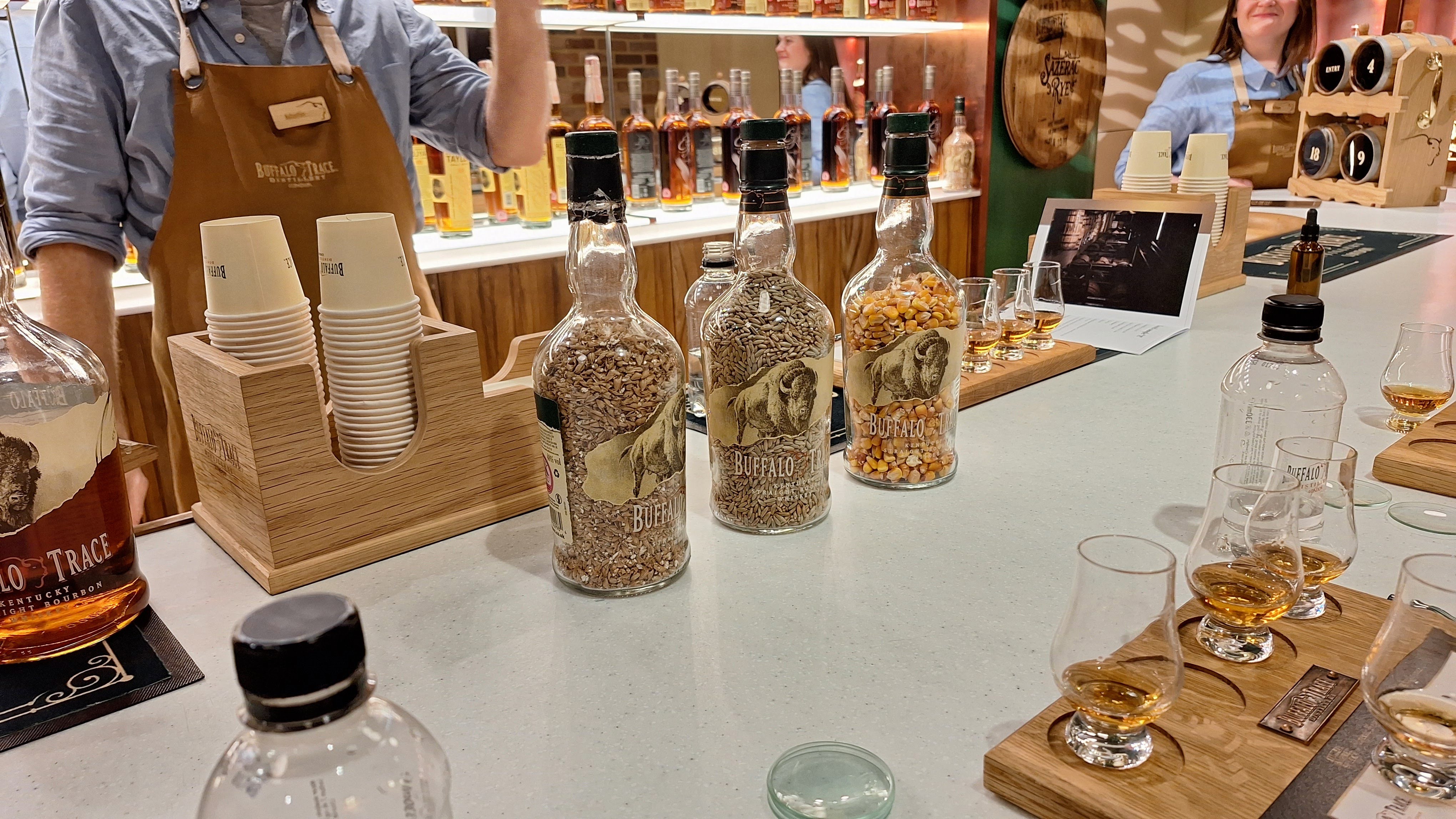 Buffalo Trace full sized bottles filled with grains to show the different ingredients used